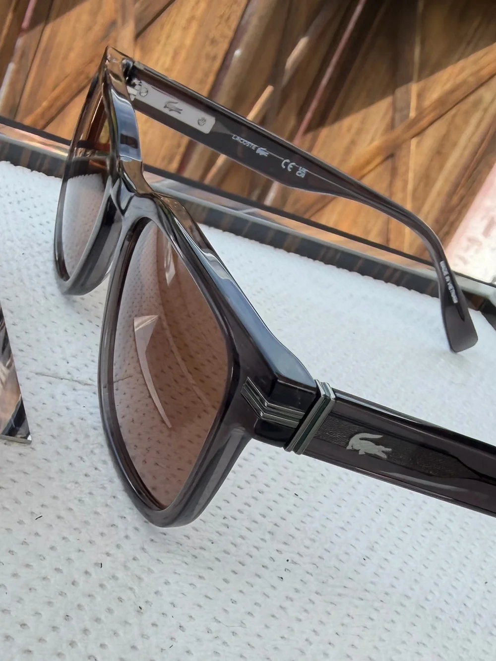 Lacoste Men’s Smoke Transparent Frame Sunglasses with Brown Lenses